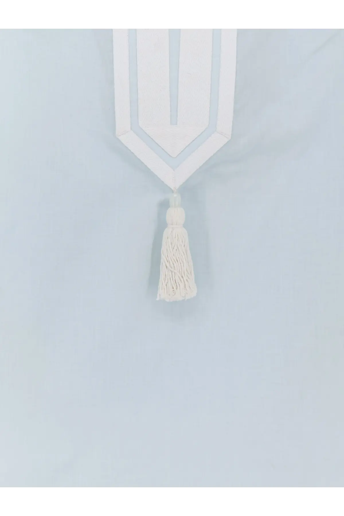 White geometric curtain tie-back with matching tassel complementing the blue cotton tory burch womens tunic shirt