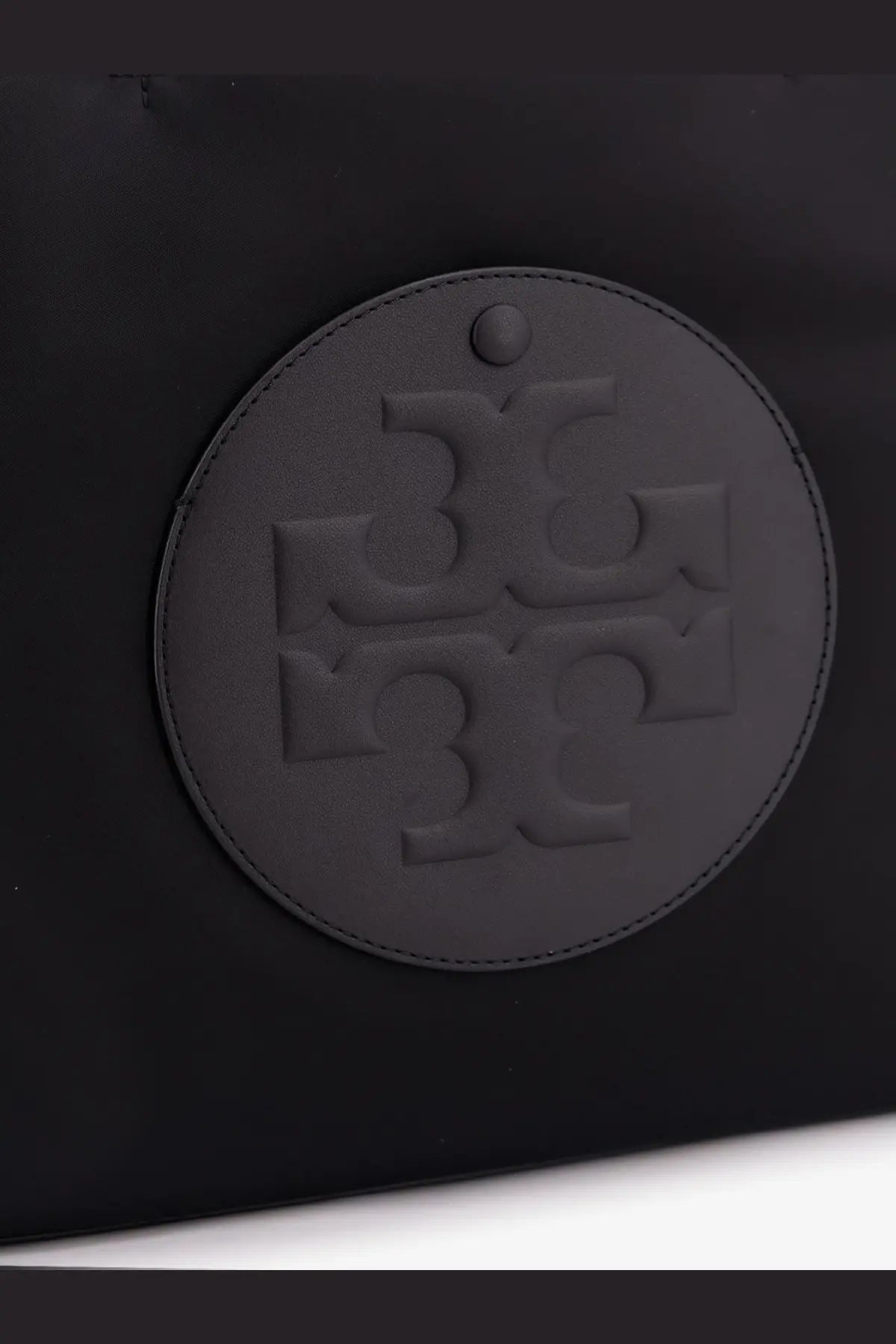 Tory Burch women’s black leather tote bag with circular embossed logo and stitched edges