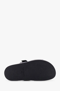 Black rubber sole with minimalist design and tommy hilfiger branding on the back of tory burch womens ines leather grey sandals