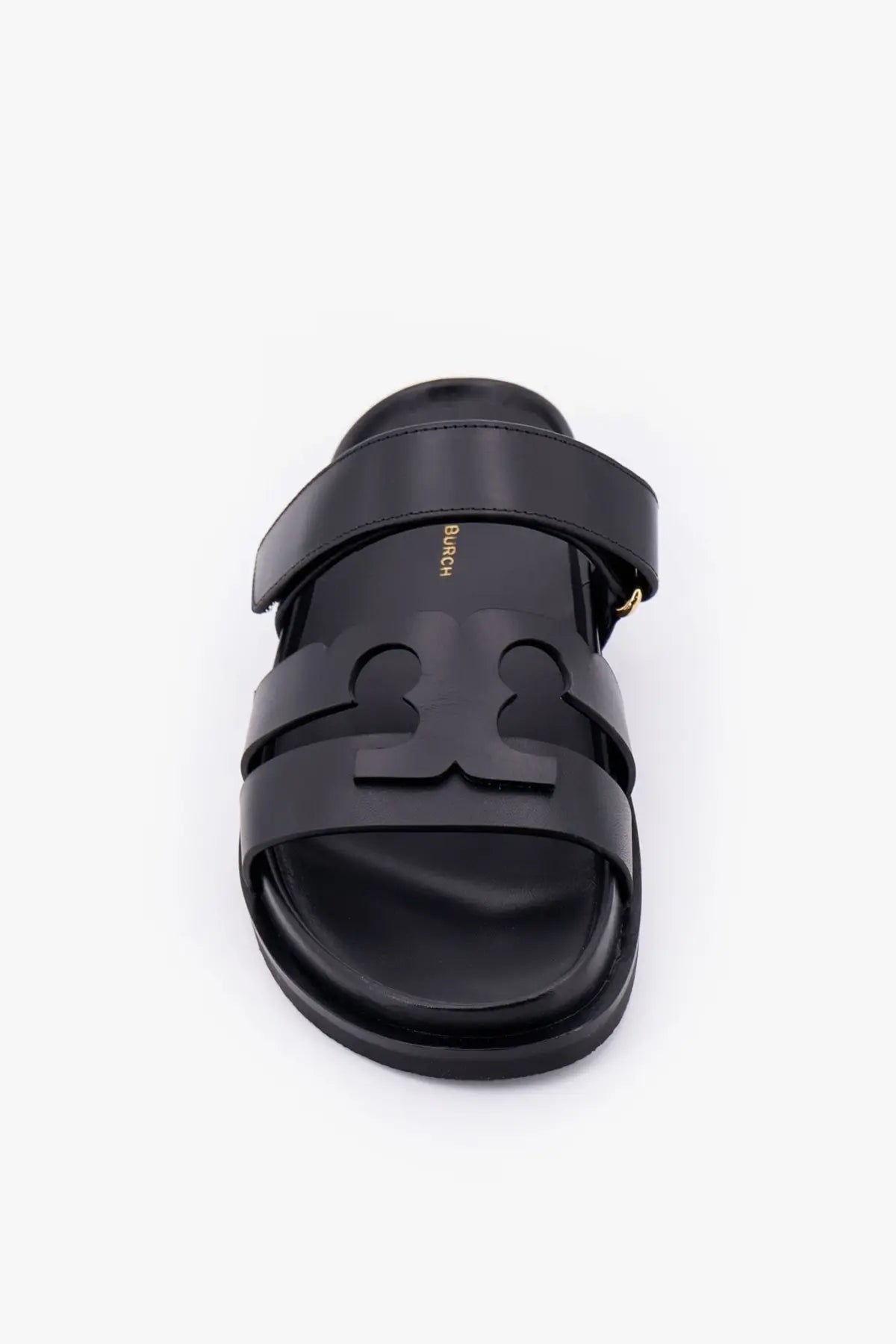 Black leather Tory Burch women’s Ines slide sandal with bold embossed logo across the footbed in grey