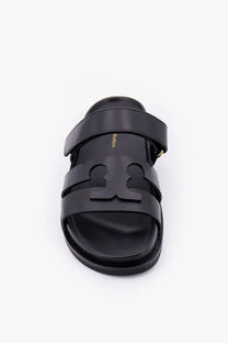 Black leather Tory Burch women’s Ines slide sandal with bold embossed logo across the footbed in grey