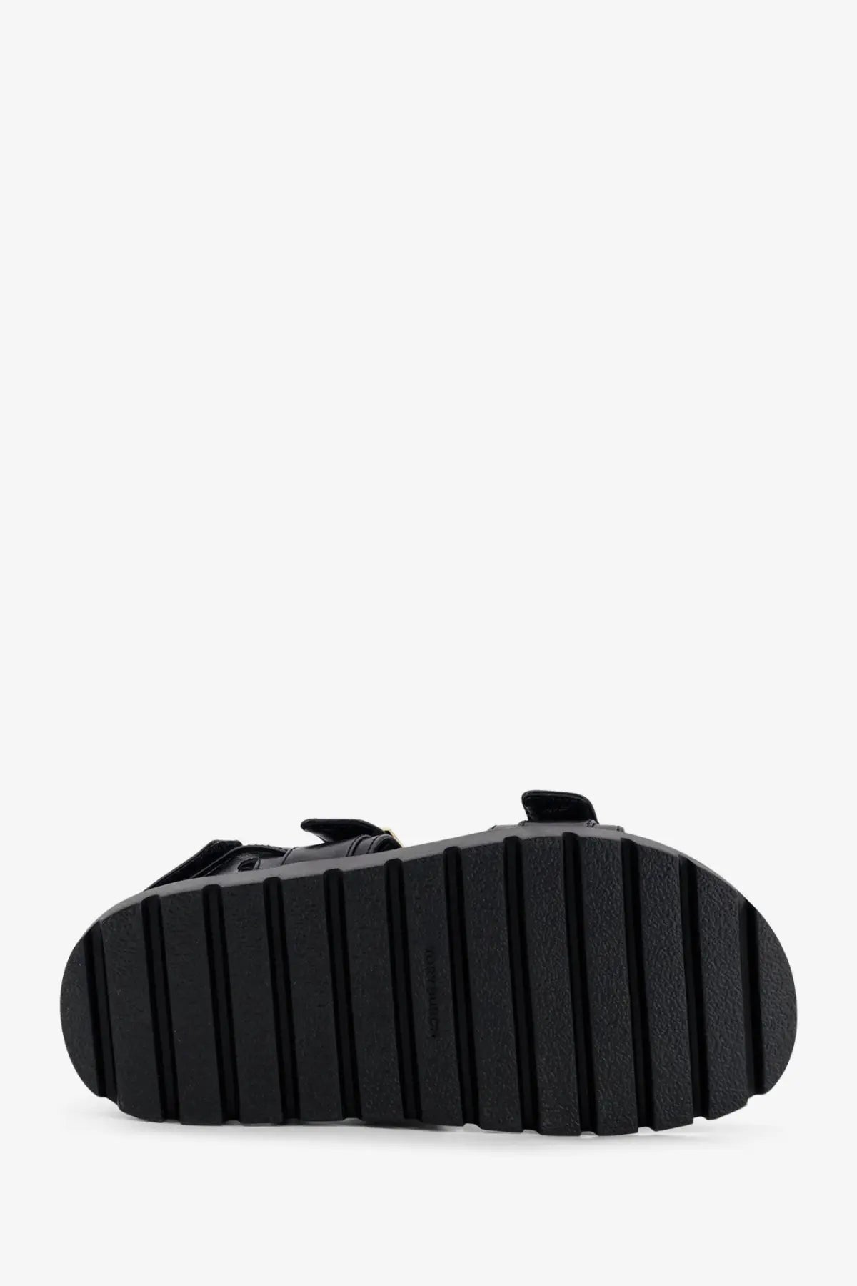 Black rubber sole with vertical ridges on the back side of tory burch women’s mellow leather sandals black