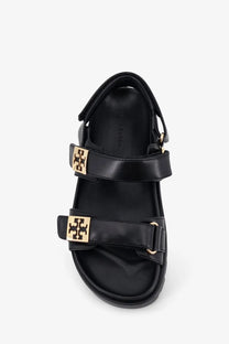 Black leather Tory Burch women’s mellow sandals with gold-tone logo buckles for stylish summer wear