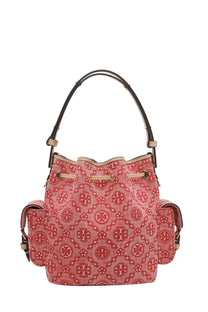 A pink Tory Burch women’s monogram canvas bucket bag with red logo pattern and black leather handles