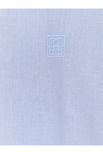 Light blue cotton and linen oversized summer shirt for women by Toteme with subtle embroidered logo on the chest
