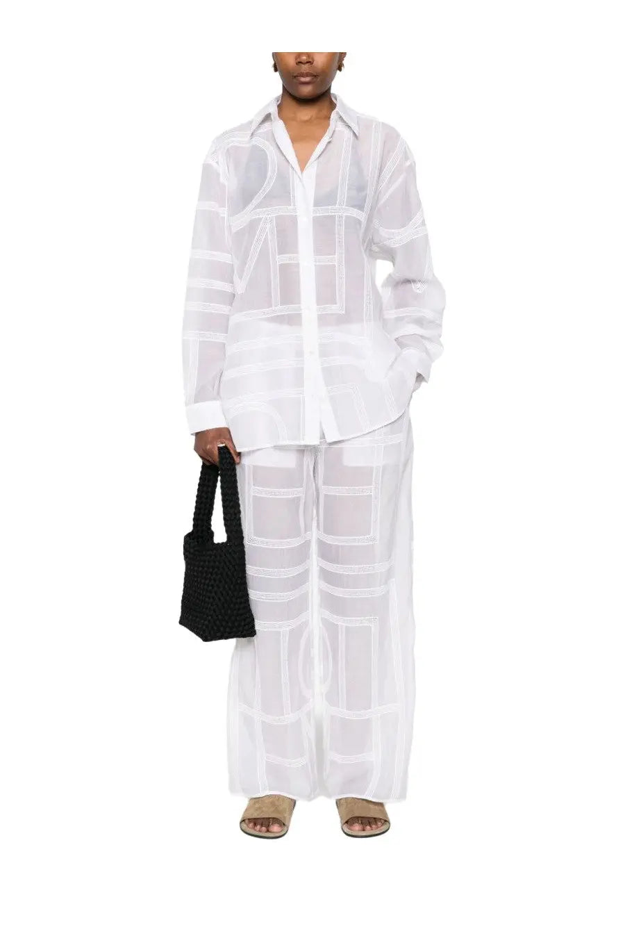 A sheer white blouse with bold black geometric lines featuring long sleeves and a classic collar for womenswear
