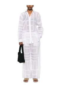 A sheer white blouse with bold black geometric lines featuring long sleeves and a classic collar for womenswear