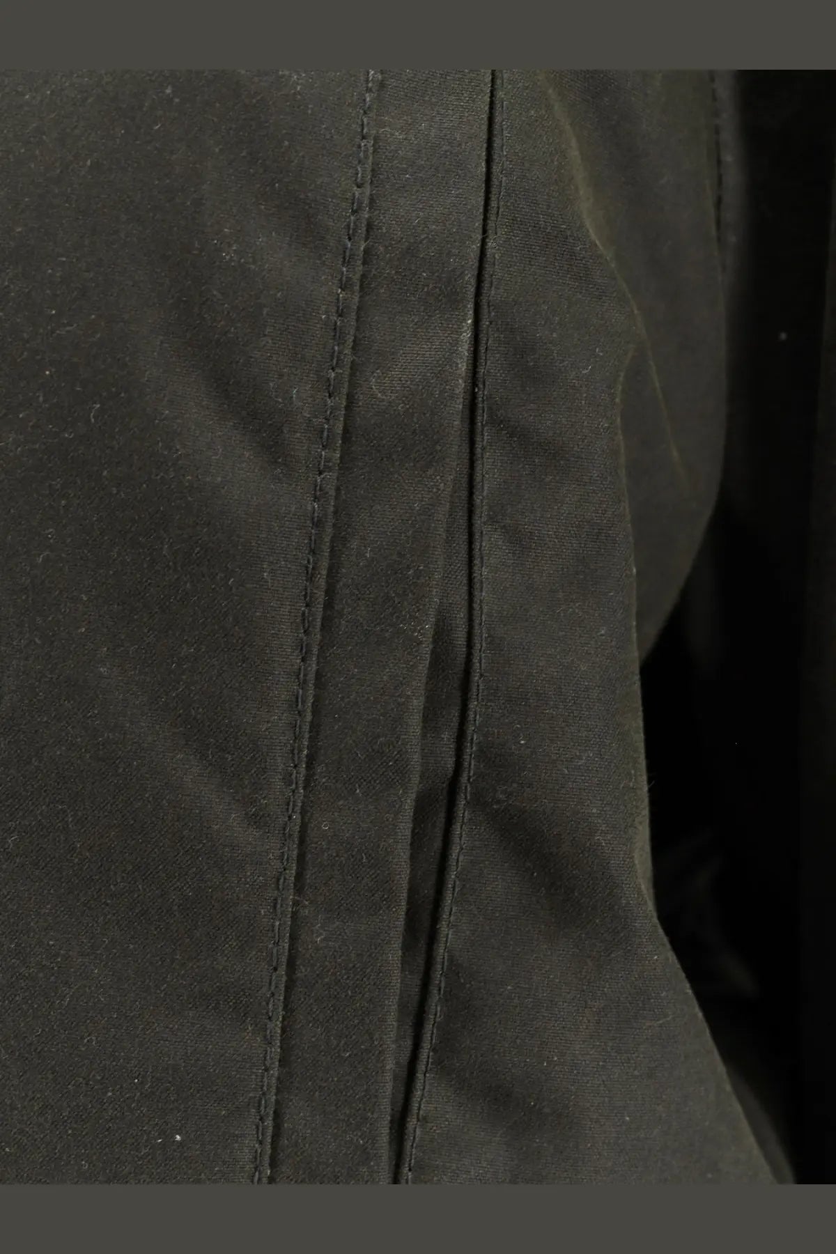 Black toteme women’s country jacket showing detailed stitching on organic cotton fabric seam