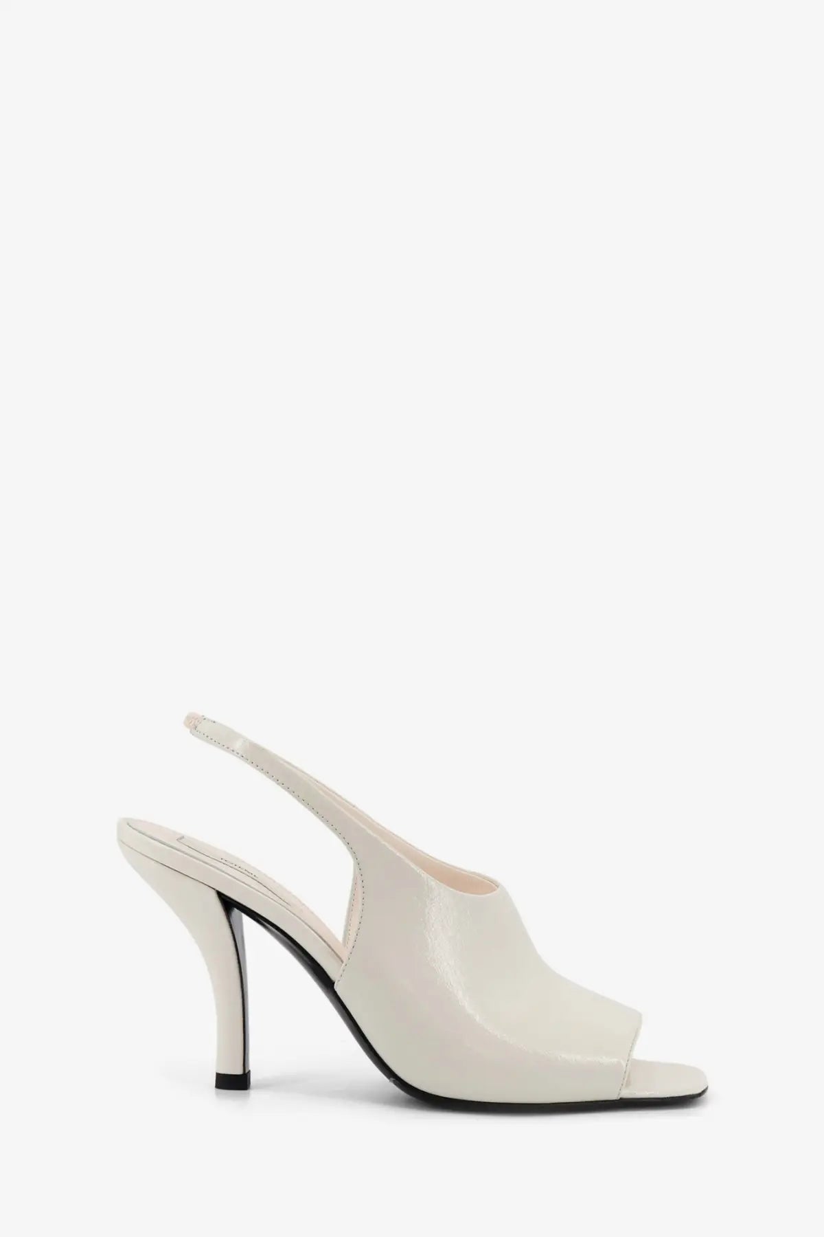 Toteme women’s cream patent leather slingback pump with sleek modern design and black heel in white contour sandals style