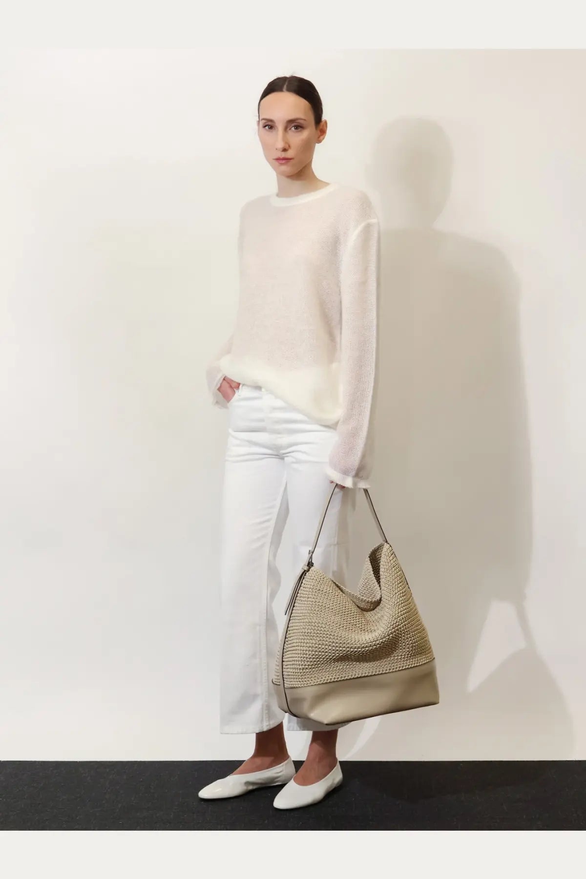 Toteme women’s beige leather shoulder bag with woven body, smooth leather bottom, and black strap