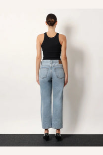 Light-wash denim jeans with high-rise wide-leg cut and classic back pockets shown from the back side
