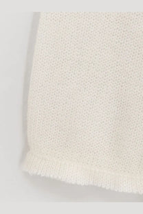 A delicate off-white knitted mohair and wool blend sweater by toteme with fine mesh pattern and softly frayed edges
