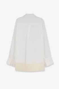 Cream-colored toteme women’s tuxedo satin viscose shirt with subtle contrast hem and elegant flowing silhouette