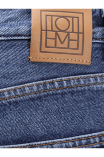 Blue denim twisted seam jeans for women with tan leather patch embossed with Loewe logo on the back waistband