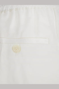 Toteme women’s white viscose trousers with subtle pleated waistband and single button closure
