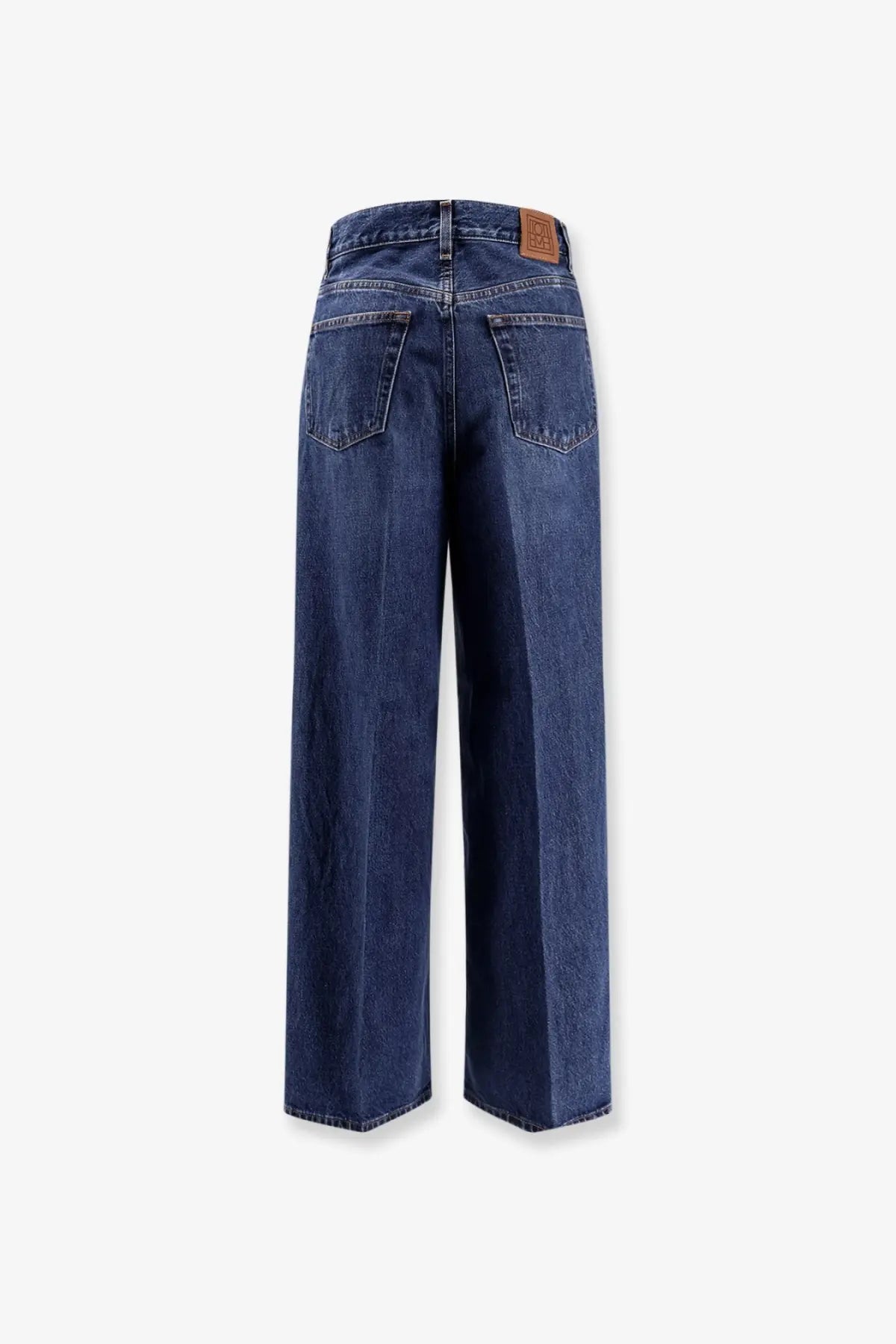 Toteme women’s wide leg organic cotton jeans in dark blue with a brown leather patch at the waistband back side