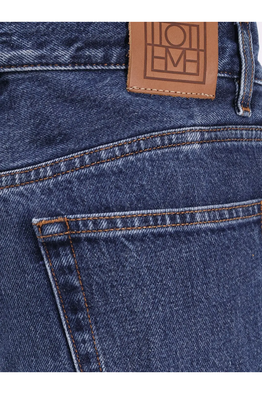 Dark blue toteme women’s wide leg organic cotton jeans showing back with brown leather embossed brand patch