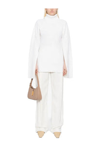 Beige leather handbag with gold-tone clasp and top handle paired with Toteme womens wool jersey pink garment