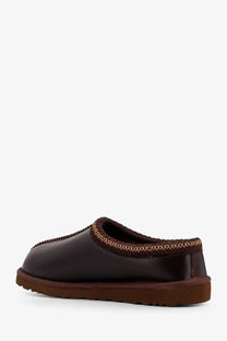 Ugg men’s tasman leather mule in grey with dark brown slip-on design and plush textured trim along the opening