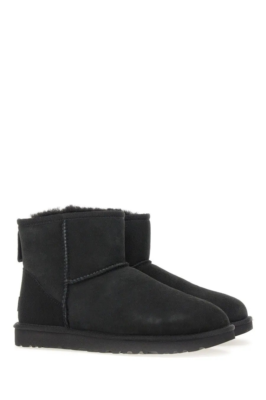 Ugg women’s classic mini boot in black with plush shearling lining and suede upper for cozy casual wear
