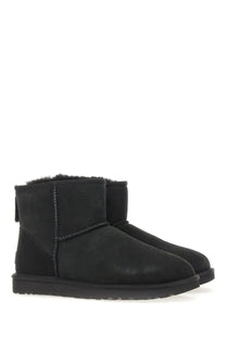 Ugg women’s classic mini boot in black with plush shearling lining and suede upper for cozy casual wear