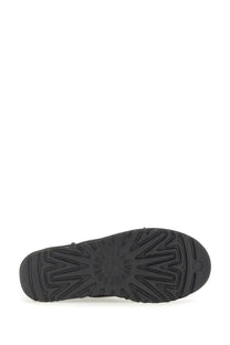 Black rubber sole with geometric tread pattern and embossed ugg logo on ugg women’s boot classic mini black back side