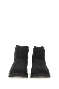 UGG women’s classic mini boot in black suede with plush shearling lining for warmth and comfort