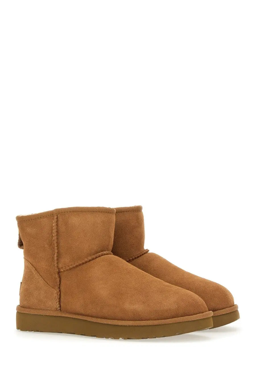 Ugg women’s classic mini brown boots in tan suede with plush interior and sturdy rubber sole