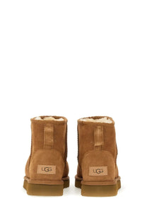 Ugg women’s classic mini brown tan suede boots with plush white lining and durable rubber sole