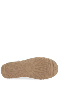 Back view of ugg women’s classic ultra mini green boot with tan rubber sole and sunburst tread pattern