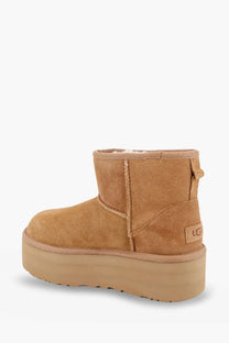 Ugg women’s classic mini platform suede ankle boot in brown with plush interior and thick matching rubber sole
