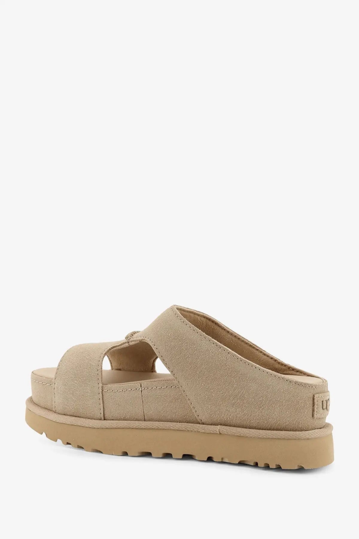 Beige suede slide sandal with chunky rubber sole and dual straps from UGG women’s Goldenstar collection