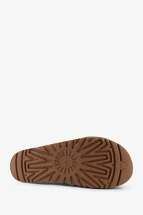 Back view of ugg women’s goldenstar suede sandals brown showing brown rubber sole with radiating tread and ugg logo near heel