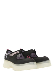 Ugg women’s mary jane areum black shoes with black platform, translucent sole, pink ribbon accents, and purple lining