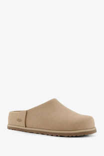 Beige ugg women’s nubuck slip-on clog with suede upper and rubber sole for comfortable casual wear