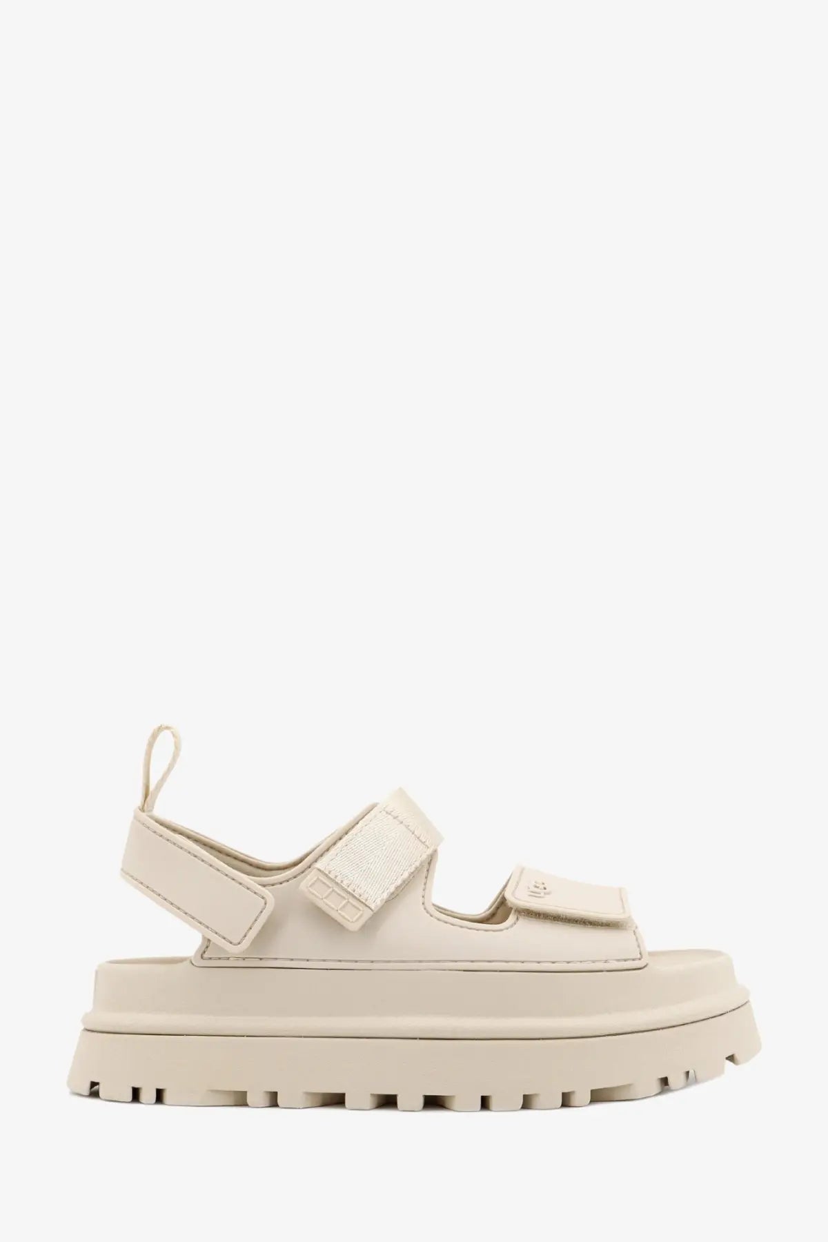 Cream-colored UGG women’s rubber platform sandal with adjustable velcro straps and chunky sole