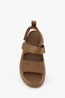 Ugg women’s brown rubber sandal with adjustable straps and a thick cushioned sole for comfortable wear