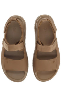 Ugg women’s sandal goldenglow brown with tan cushioned sole and adjustable velcro straps for comfortable wear