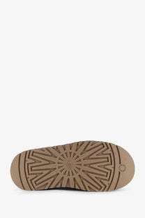 Tan rubber sole with sunburst tread pattern and ugg logo embossed on ugg women’s tazz suede sandals beige