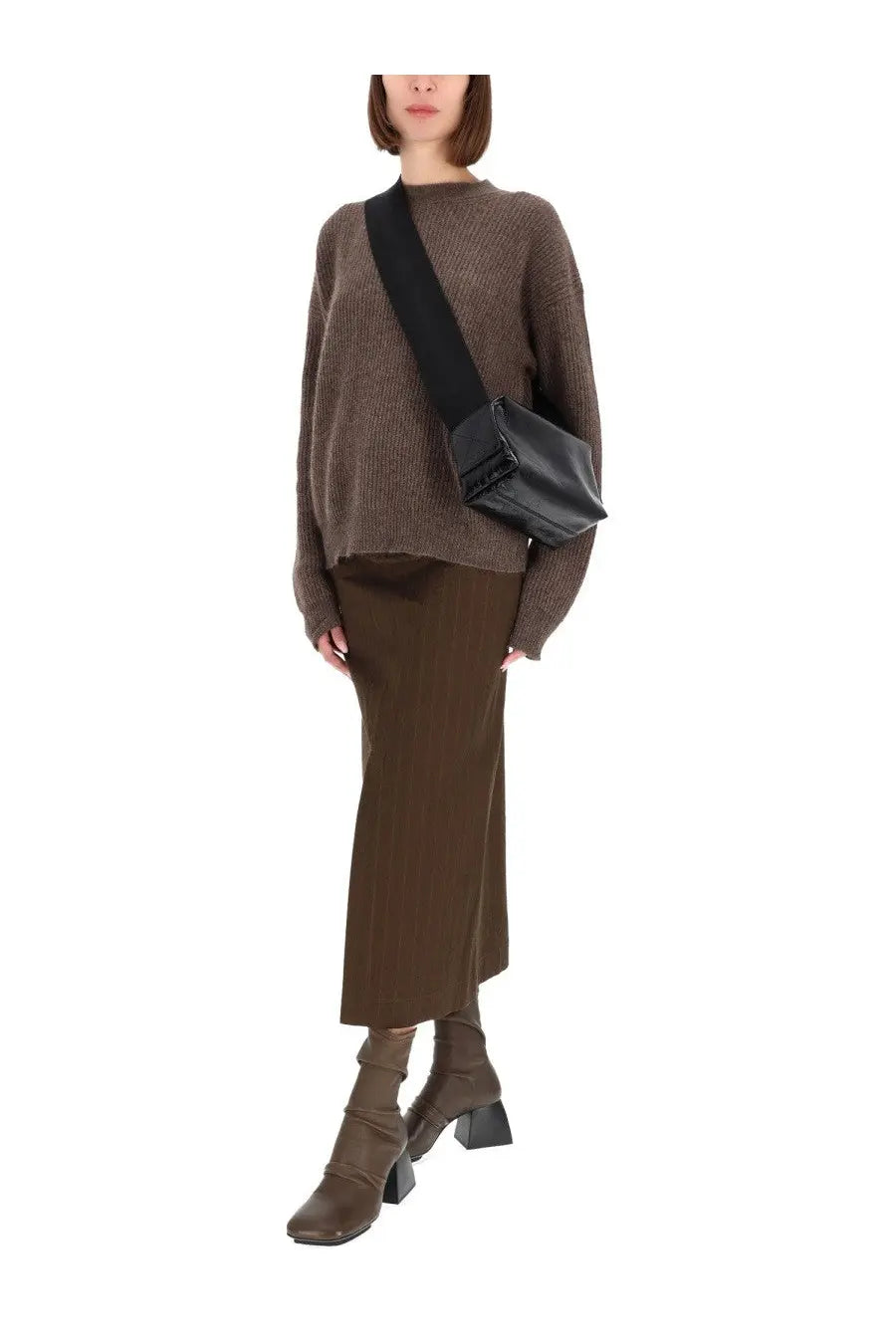Black leather crossbody bag with structured rectangular shape and minimalist design complementing uma wang midi gad skirt