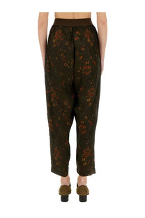 Uma wang women’s pants in palmer green featuring dark olive green floral print wide-leg trousers with matching elastic waistband