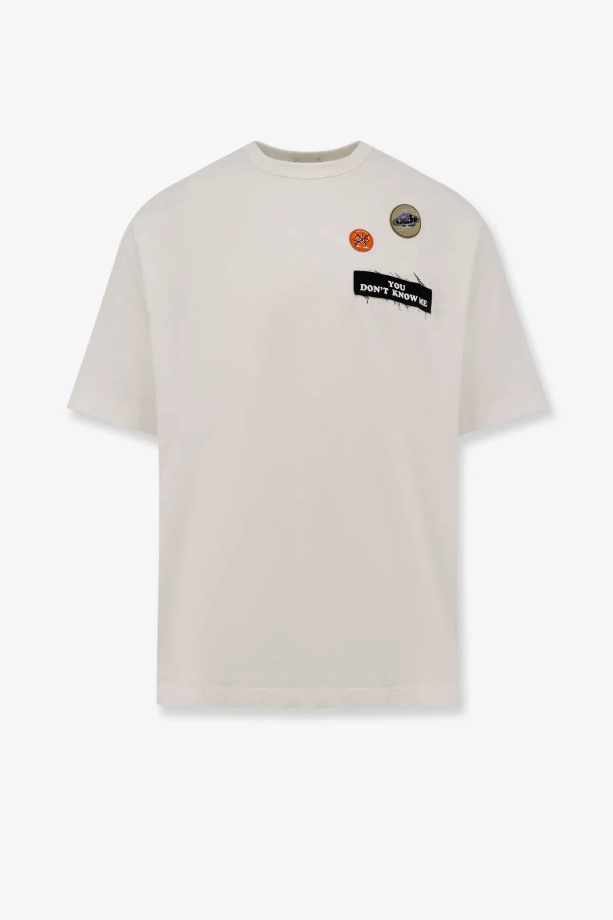 Undercover men’s cream cotton t-shirt with black you don t know us patch and two decorative pins on left chest