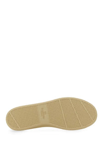 Beige rubber sole with textured pattern and valentino branding on valentino men’s white leather sneaker