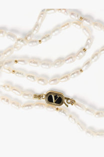 Valentino men’s metal necklace white featuring a delicate white freshwater pearl strand and gold-toned clasp with embossed black v logo