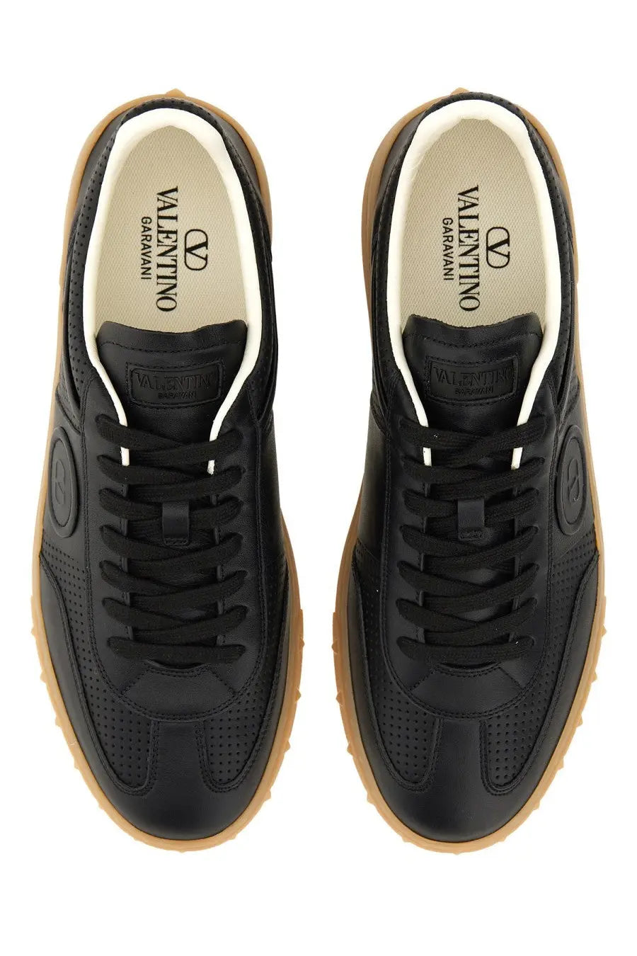 Valentino men’s upvillage sneaker black leather with tan rubber soles and white laces shown from the back side