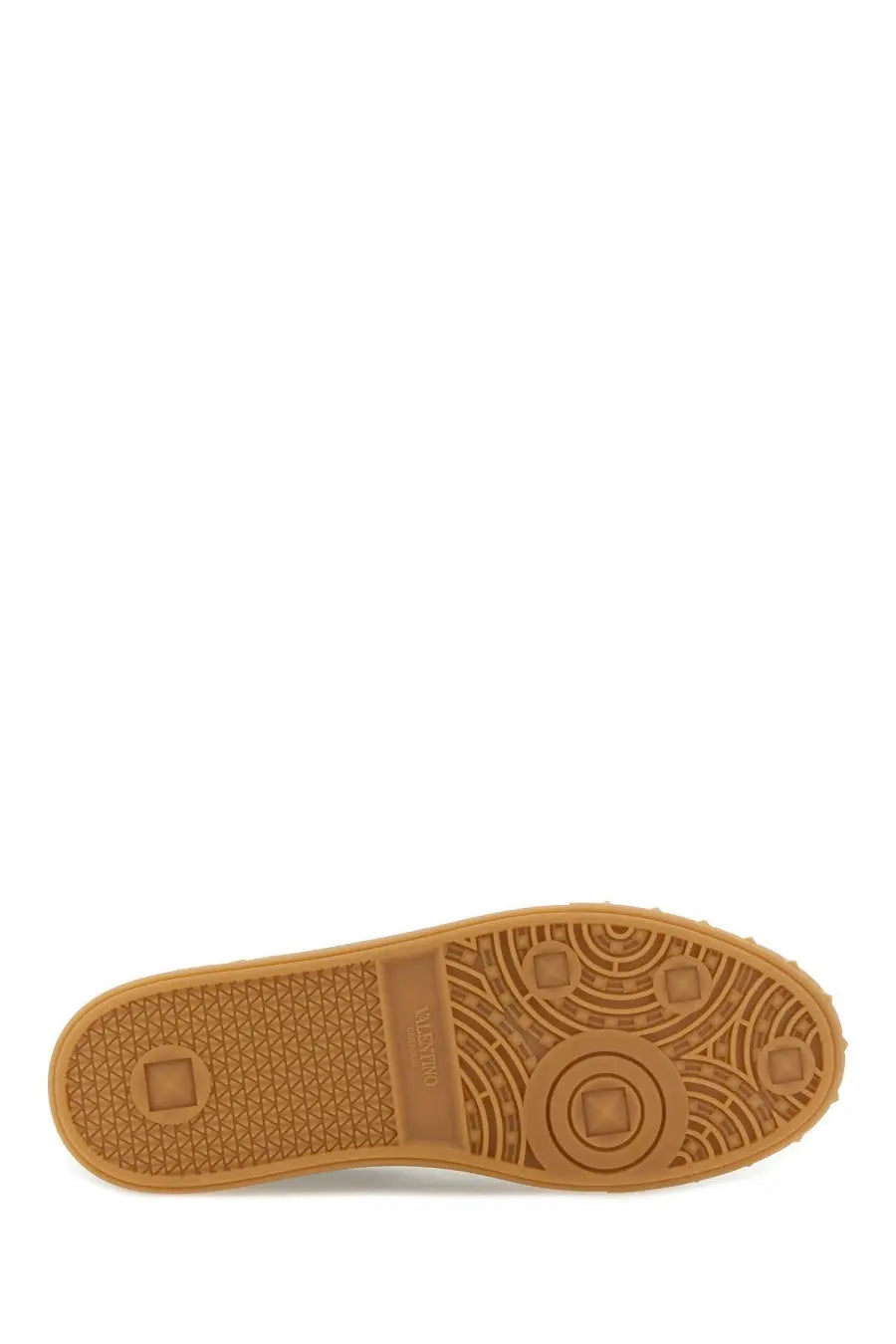 Tan rubber sole with textured pattern and circular design on valentino men’s upvillage sneaker black