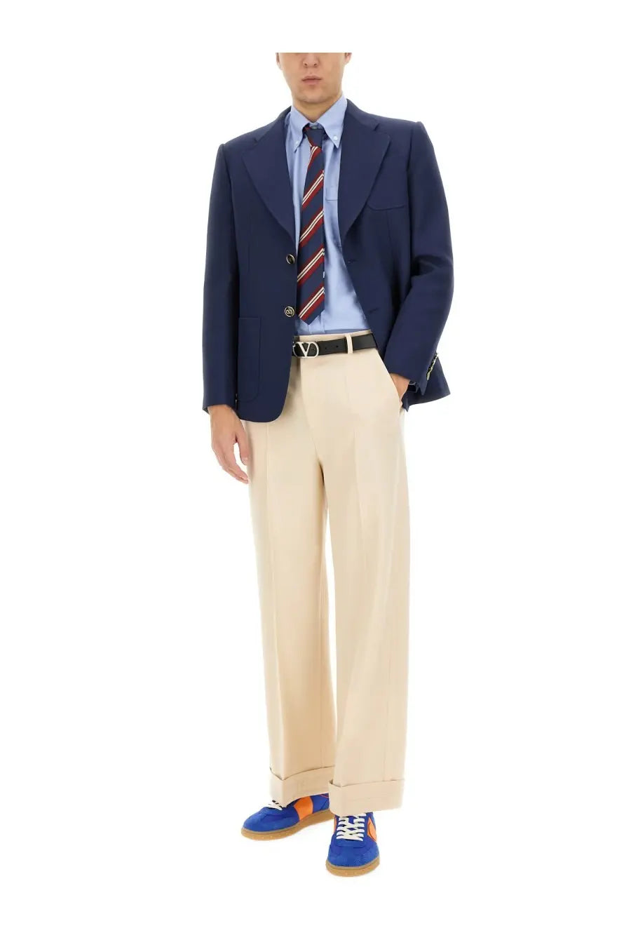 Navy blue three-button wool blazer with notched lapels paired with valentino men’s beige wool pants