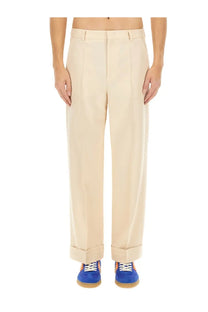 Valentino men’s beige wool pants with tailored fit pleats and rolled cuffs for a stylish look