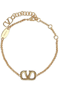 Valentino women’s gold-tone chain bracelet with vlogo charm embedded stones and oval tag engraved vltn