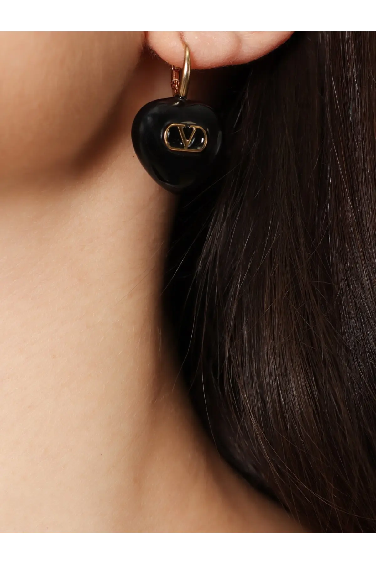 Black heart-shaped metal earring with gold-tone Valentino logo from Valentino women’s Coeur royal collection